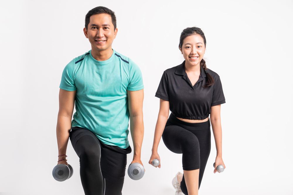 A man is training with a female personal trainer singapore