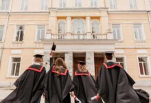 4 university students in convo gown showing their ba