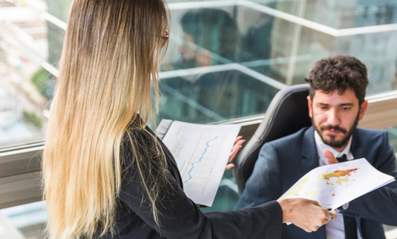 A business-suited woman holds a paper, representing expert advice for achieving career success and job search clarity.