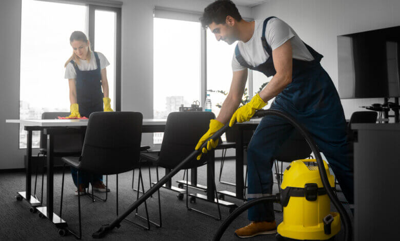 Two individuals cleaning a room with a vacuum, representing trusted janitorial services in Virginia.