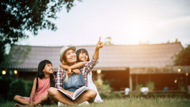 Mom with daughters, outside their house.