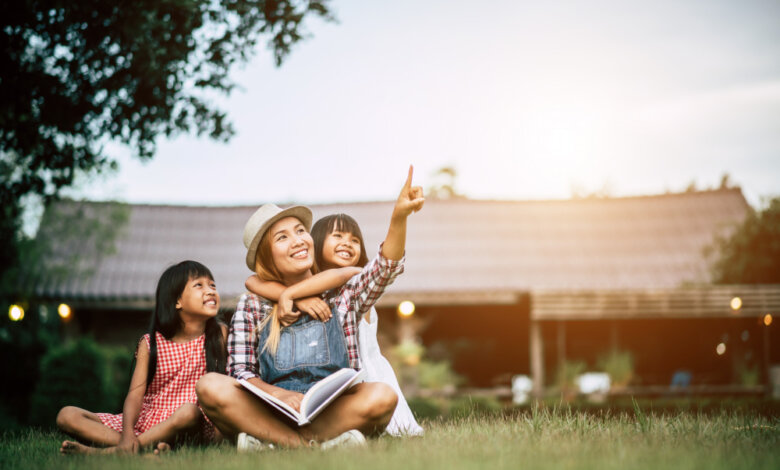 Mom with daughters, outside their house.