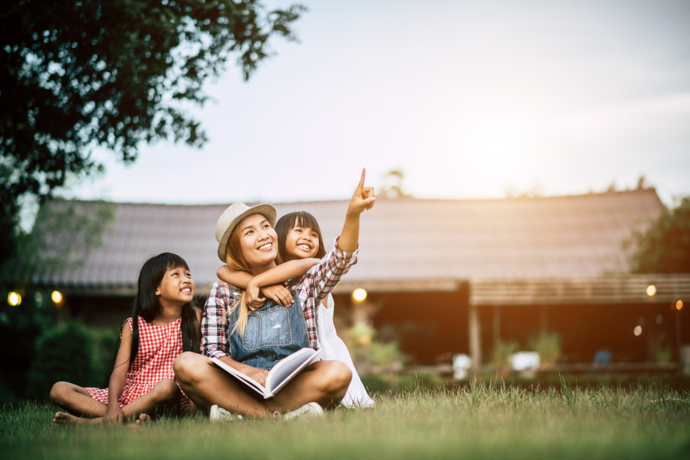 Mom with daughters, outside their house.