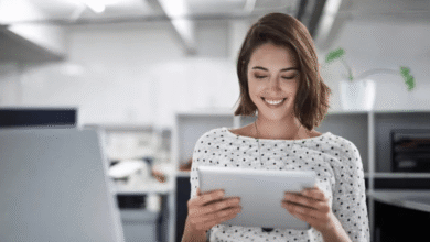 A smiling woman using a tablet computer, engaged and enjoying her digital experience